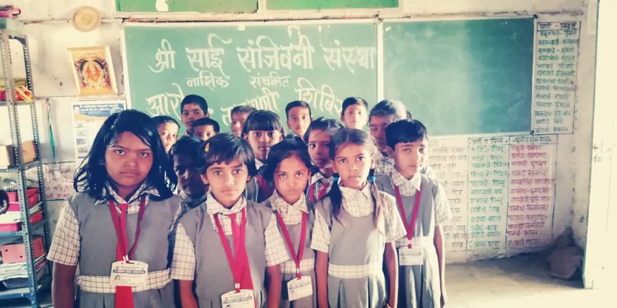 Students at a school health camp. Waiting their turn at an Aarogya Tapasni Shibir