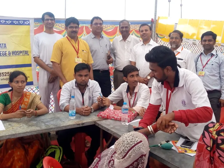 Health camp with a medical college team. Blood pressure and general screening under a camp tent